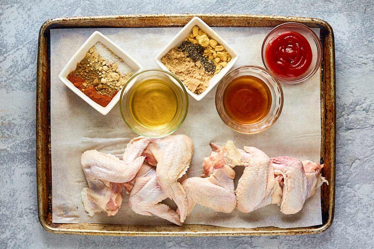 baked bbq chicken wings ingredients on a tray.