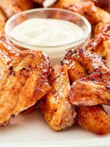 baked bbq chicken wings and ranch sauce.