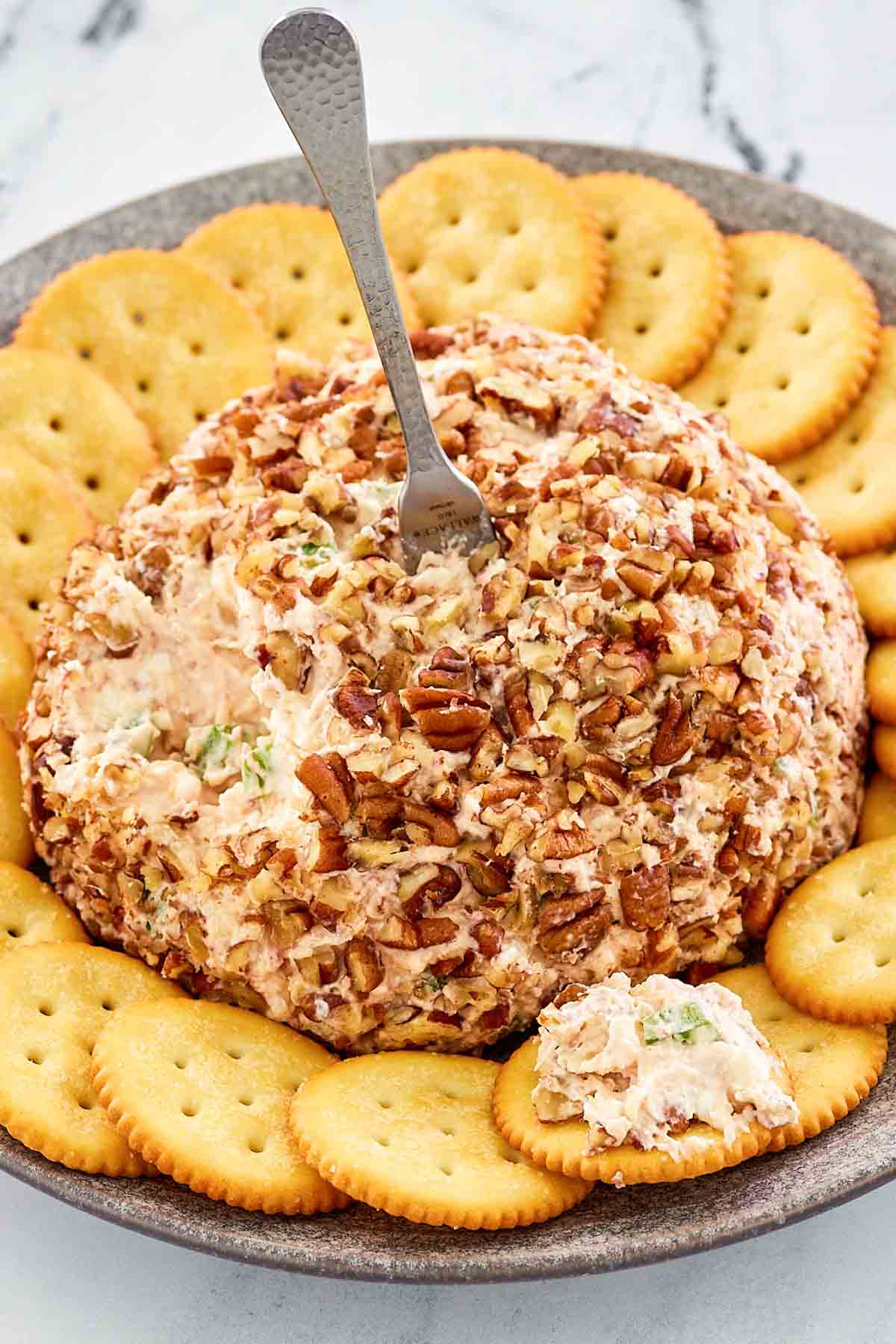 deviled ham cheese ball and crackers on a platter.