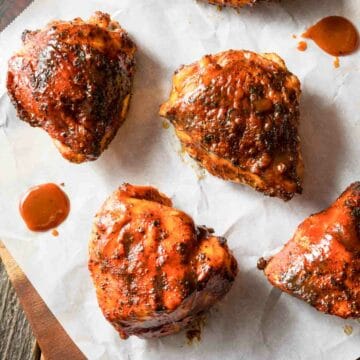 grilled bbq chicken thighs on parchment paper.
