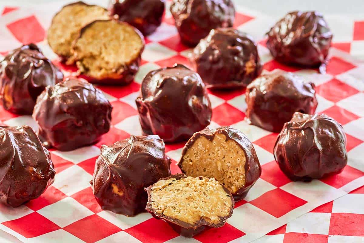 rice krispie peanut butter balls covered in chocolate on parchment paper.