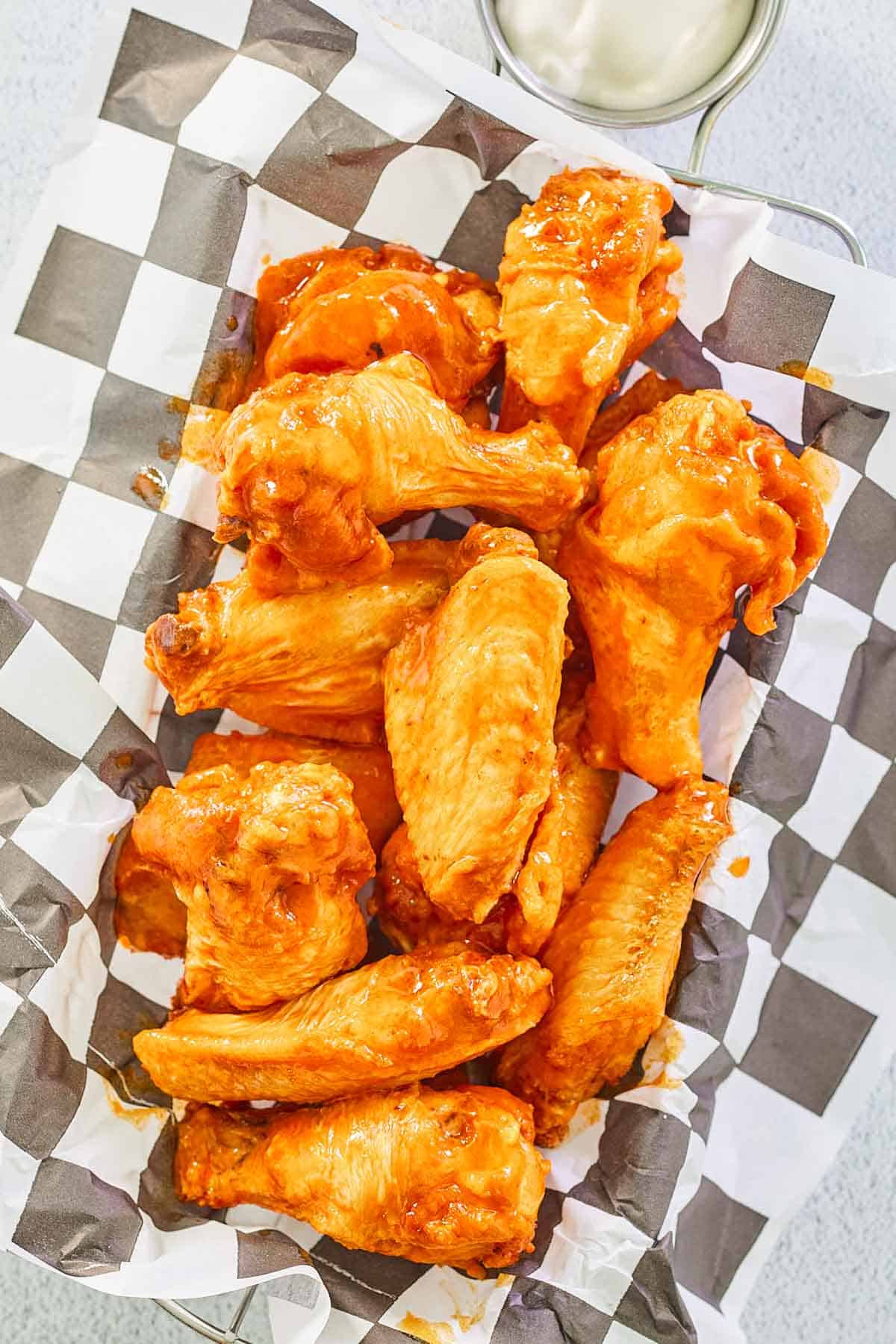 overhead view of Louisiana hot sauce wings in a basket.