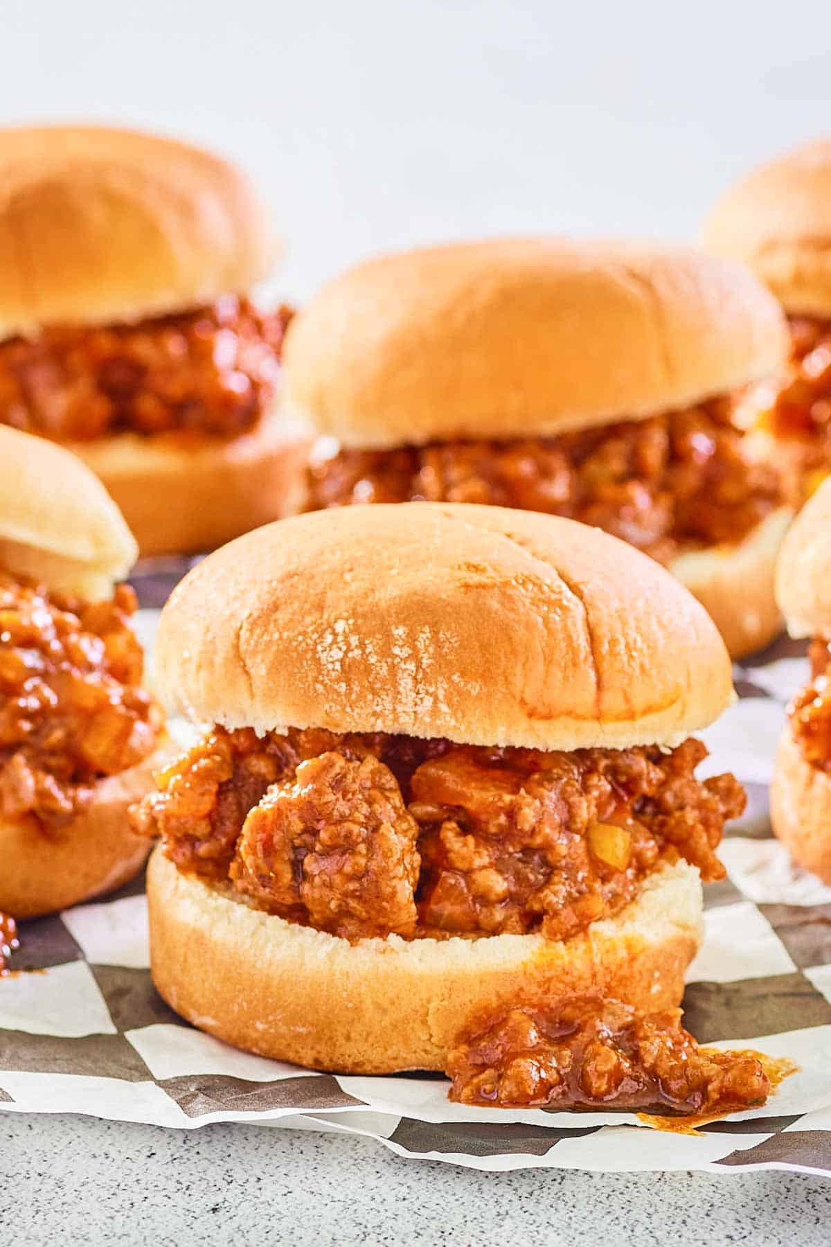 sloppy joe sliders scattered on parchment paper.