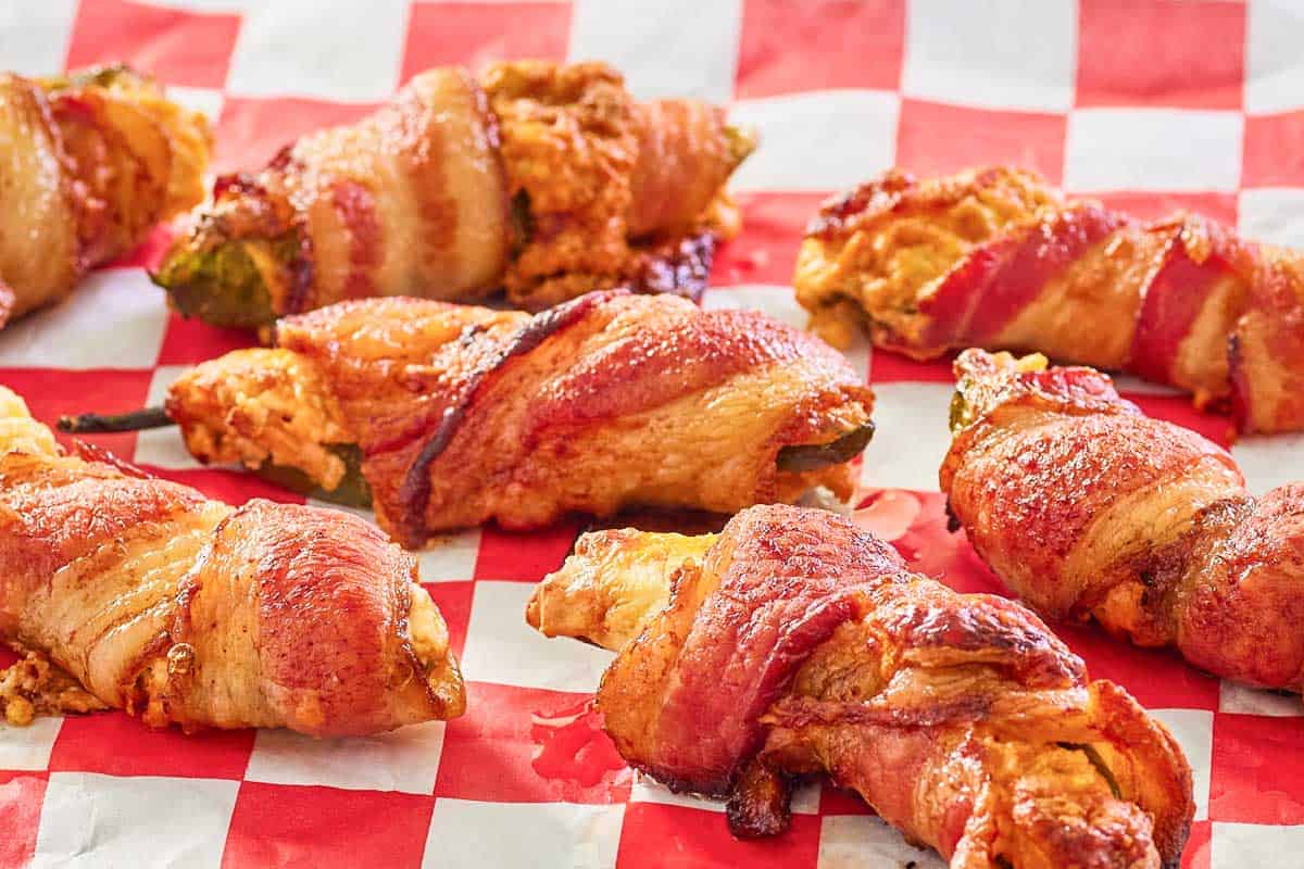 bacon wrapped smoked jalapeno poppers on parchment paper.