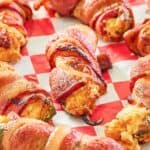 smoked bacon wrapped jalapeno poppers on parchment paper.