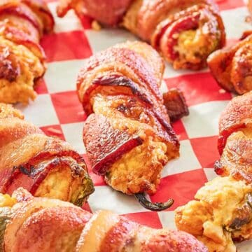 smoked bacon wrapped jalapeno poppers on parchment paper.