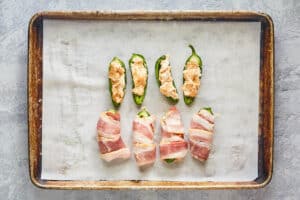 jalapeno peppers stuffed with cheese and wrapped in bacon.