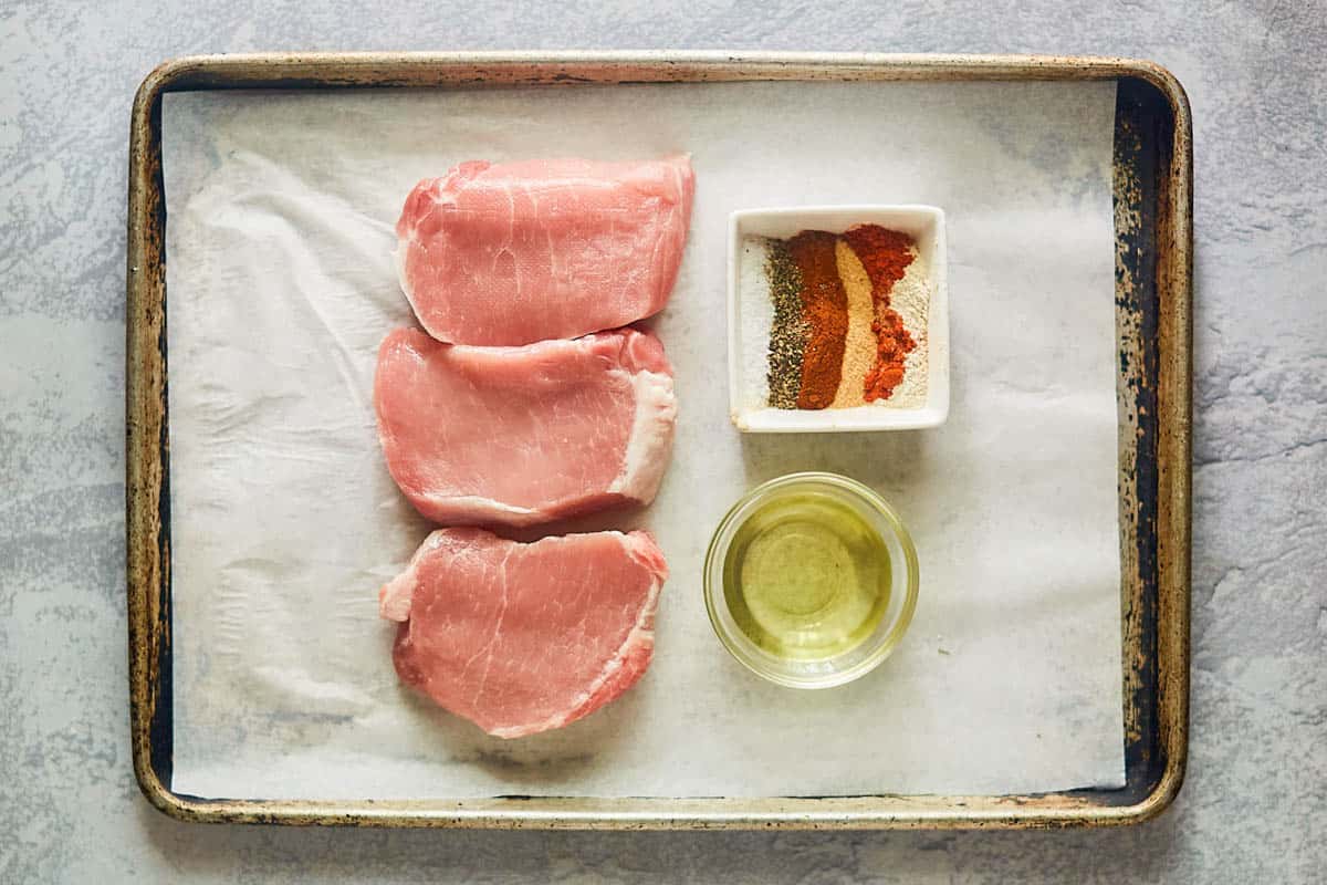 ingredients for smoked pork chops on a tray.