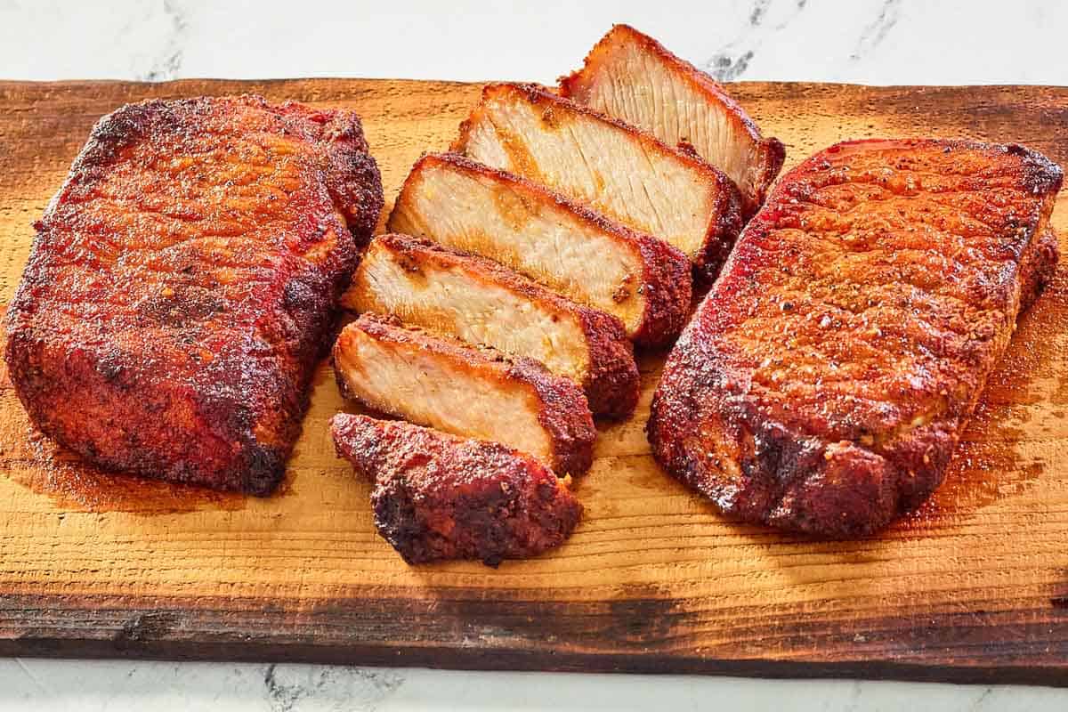 smoked pork chops on a wood board.