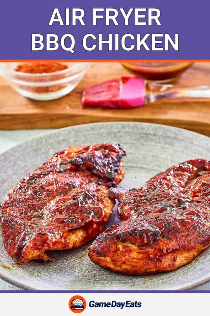 two air fried bbq chicken breasts on a grey plate.