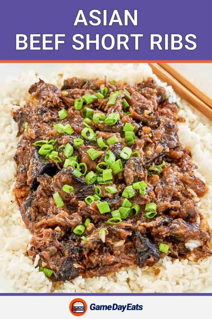 Asian beef short ribs on top of steamed white rice on a platter.