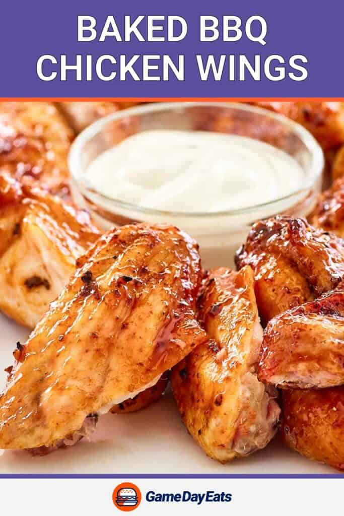 closeup of baked barbecue chicken wings and dipping sauce.