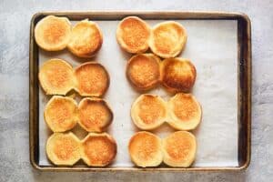 toasted slider buns on a baking sheet.