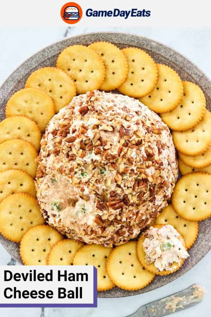 overhead view of deviled ham cheese ball and crackers on a grey platter.