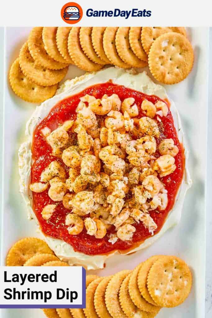 overhead view of layered shrimp dip and crackers on a platter.