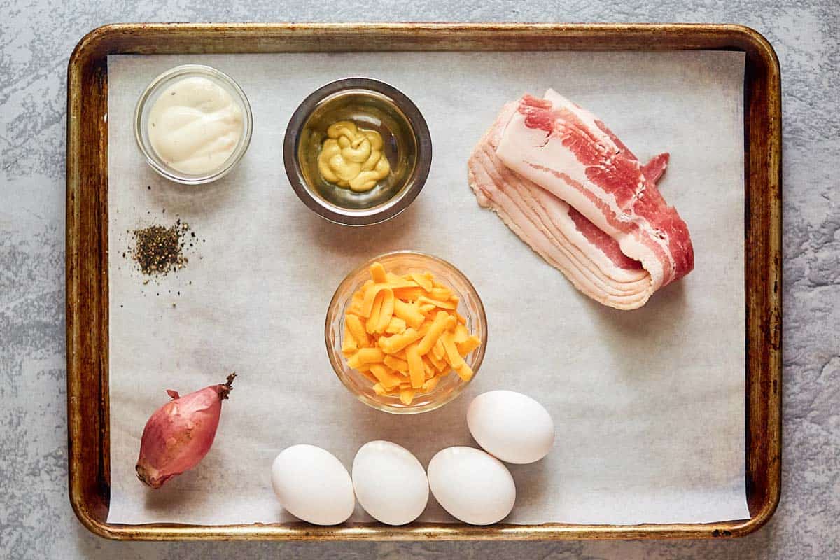 Bacon ranch deviled eggs ingredients on a tray.
