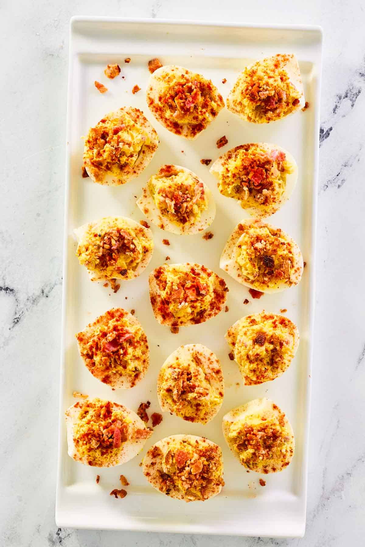 Overhead view of bacon ranch deviled eggs on a platter.