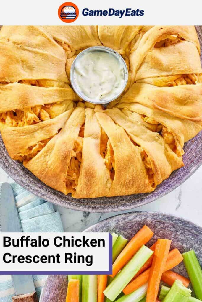 Overhead view of a buffalo chicken crescent ring and a plate of carrot and celery sticks.
