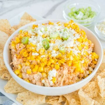 Mexican corn dip in a bowl and tortilla chips.