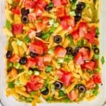 Layered taco dip with refried beans.