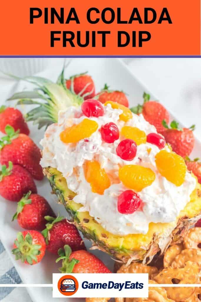 Pina colada fruit dip in a pineapple topped with cherries and mandarin oranges.