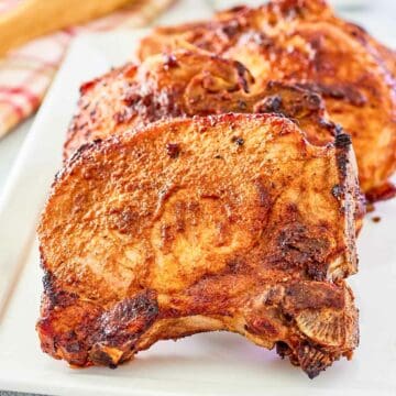 Air fryer thick pork chops on a platter.
