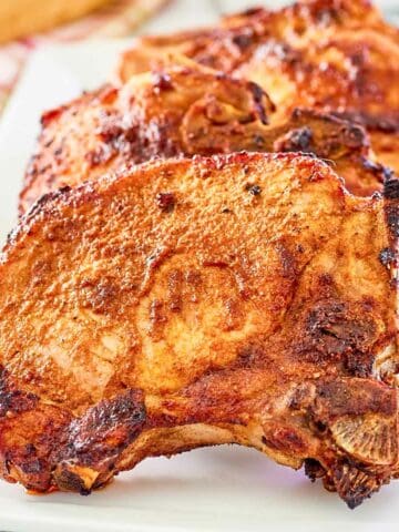 Air fryer thick pork chops on a platter.