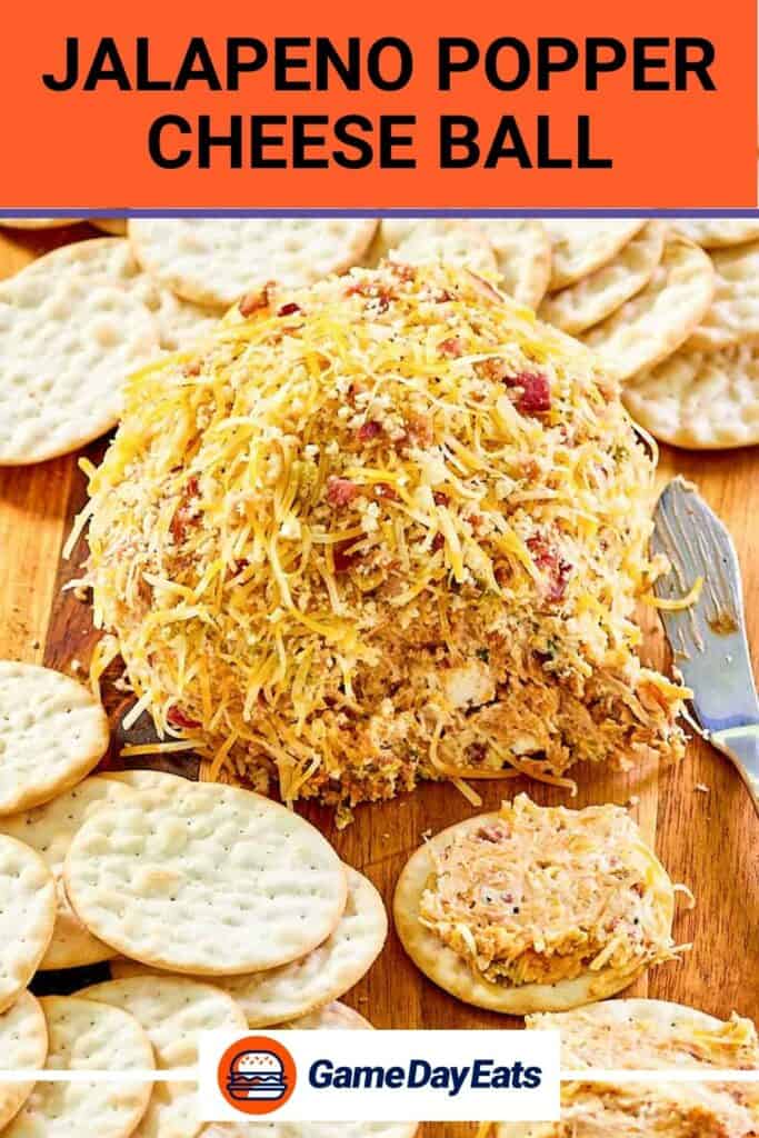 Jalapeno popper cheese ball coated with shredded cheese and bacon.