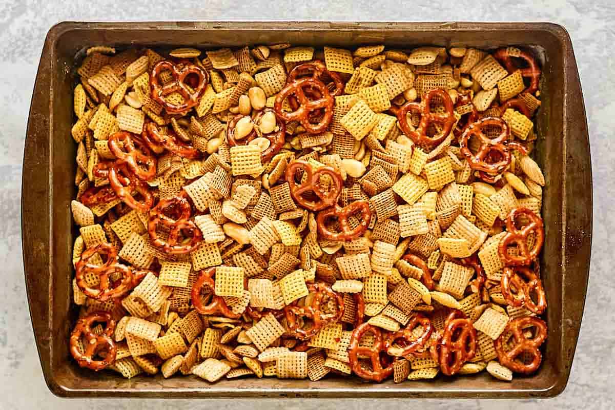 Homemade chex mix mixture in a pan before smoking it.