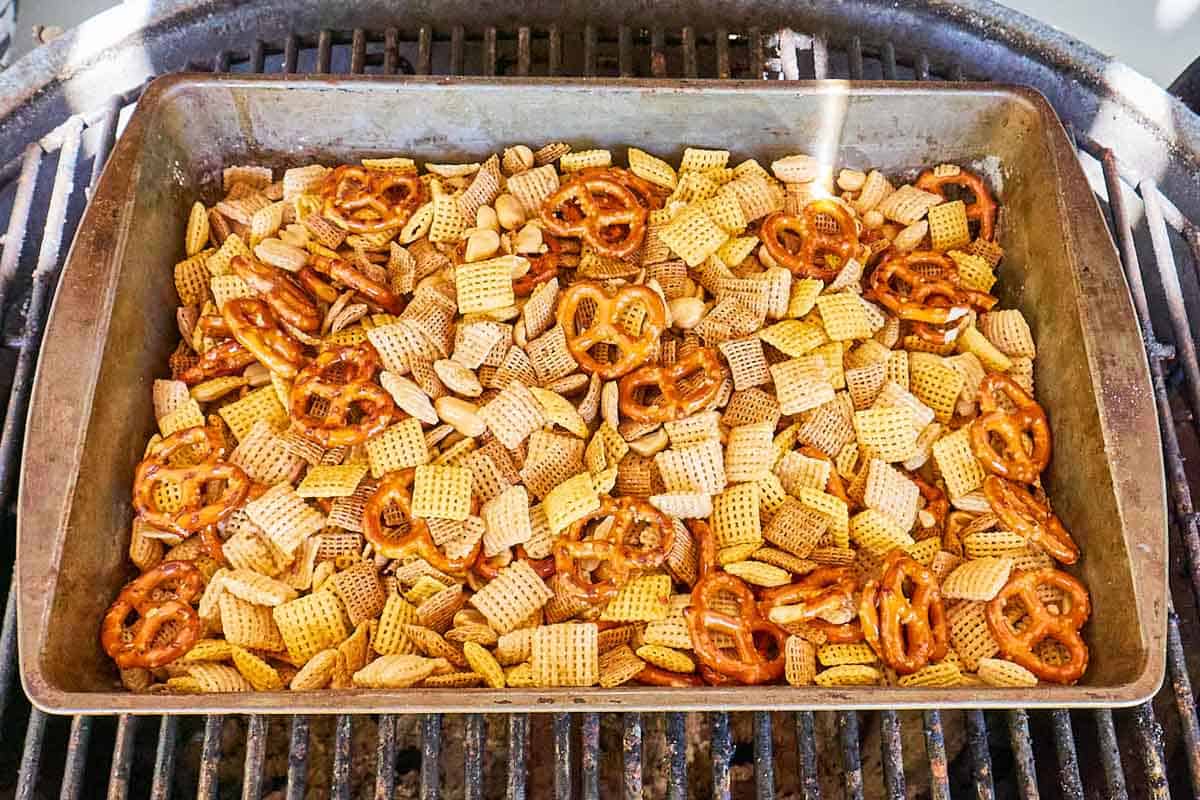 Homemade chex mix in a smoker.