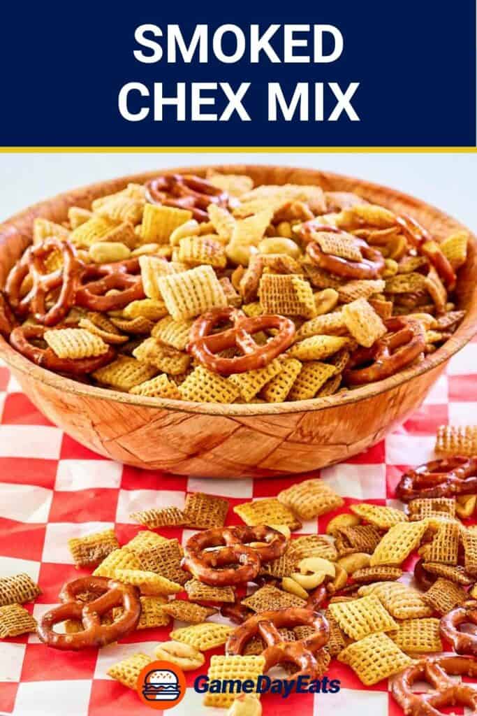 Smoked chex snack mix in a bowl and on parchment paper.