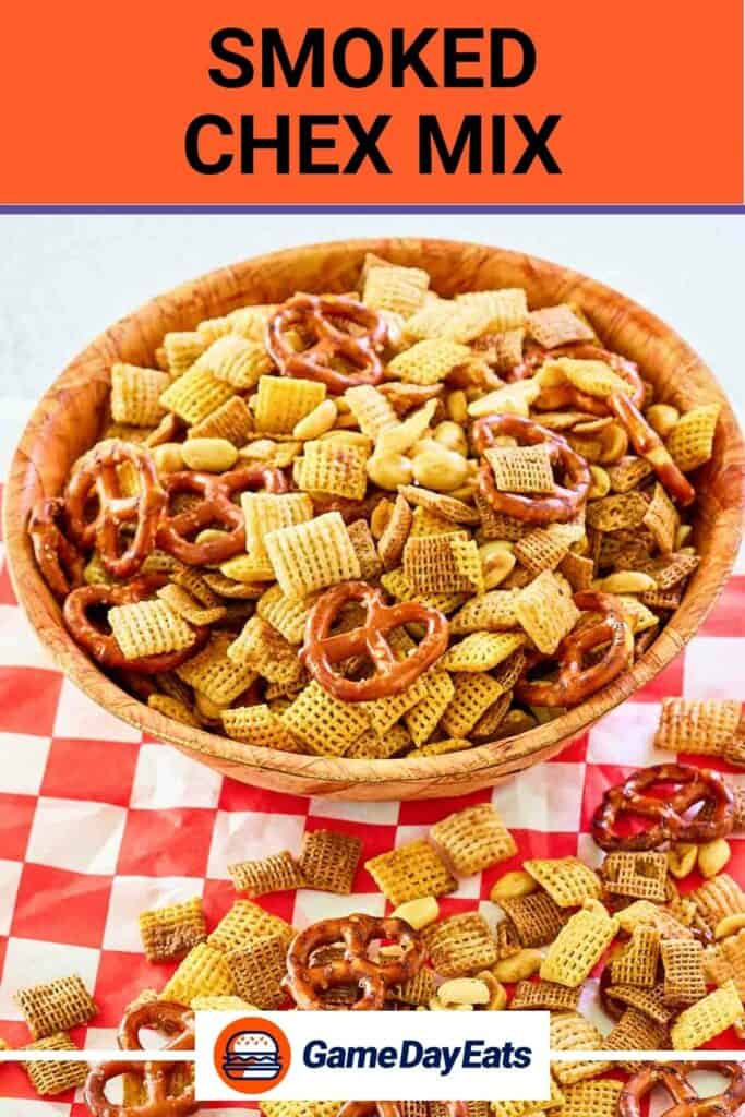 Homemade smoked chex mix in a wood bowl and on parchment paper.