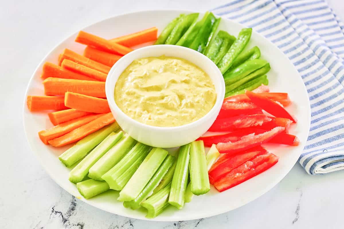 Curry dip and vegetables on a platter.
