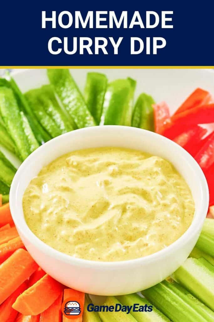 A bowl of homemade curry dip with vegetables around it.