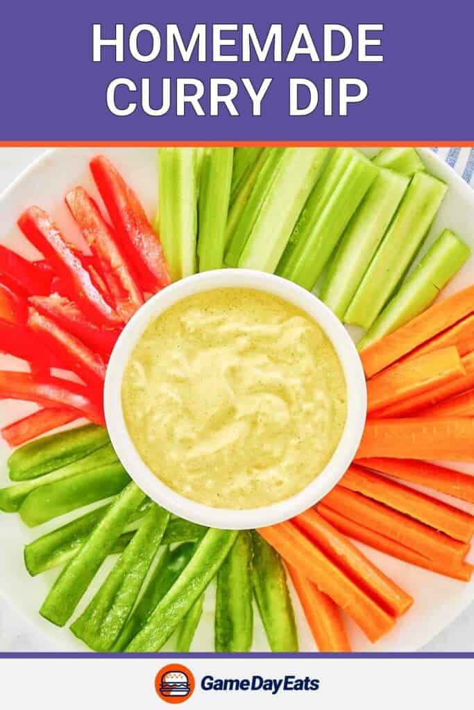 Curry dip with sliced vegetables around it.