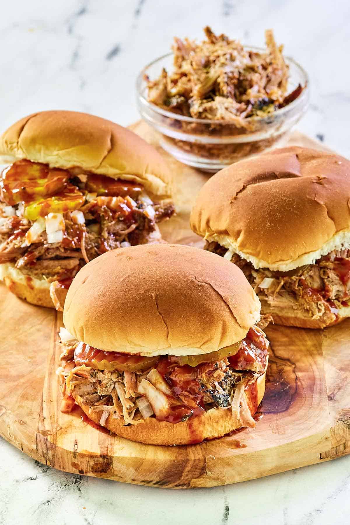 Smoked pulled pork in sandwiches and a bowl.