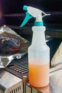 Spray bottle with mixture for smoked pulled pork.