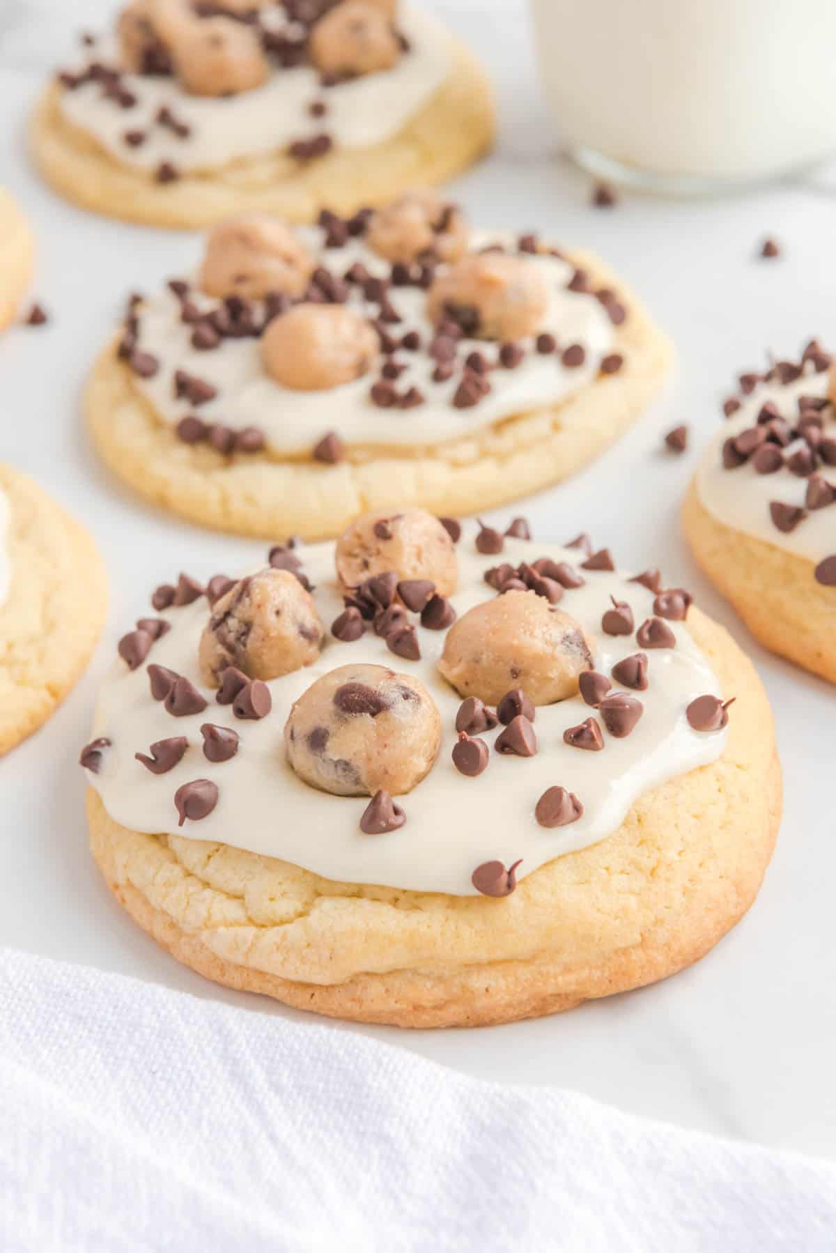 Several cookie dough cookies on a marble surface.