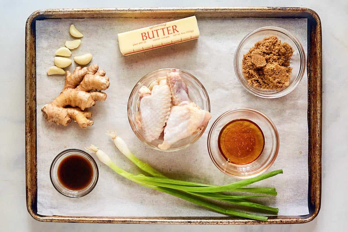 Honey garlic chicken wings ingredients on a tray.