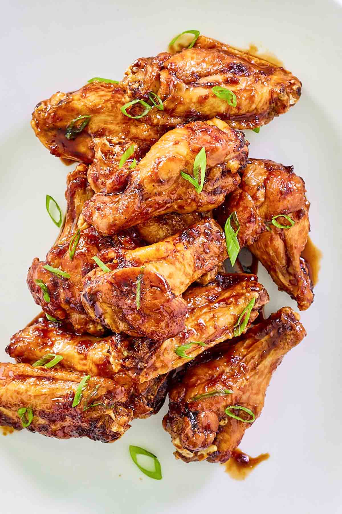 Overhead view of honey garlic chicken wings on a plate.