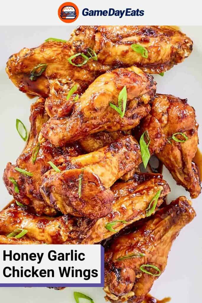 Overhead view of honey garlic wings on a white platter.