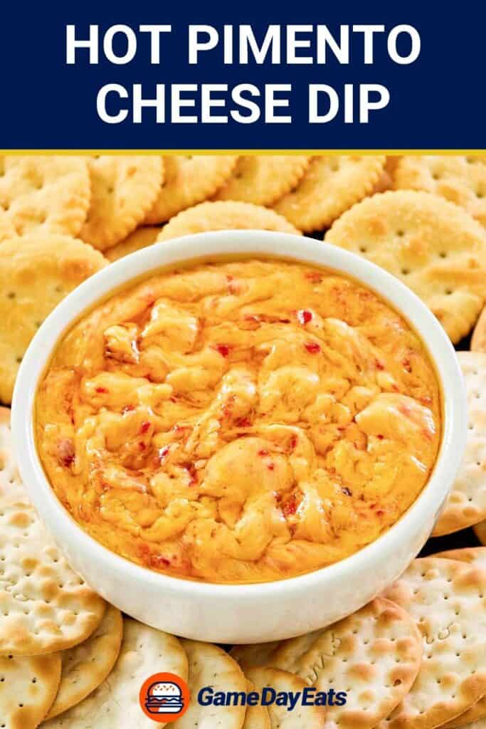 Hot pimento cheese dip in a bowl and two types of crackers around it.