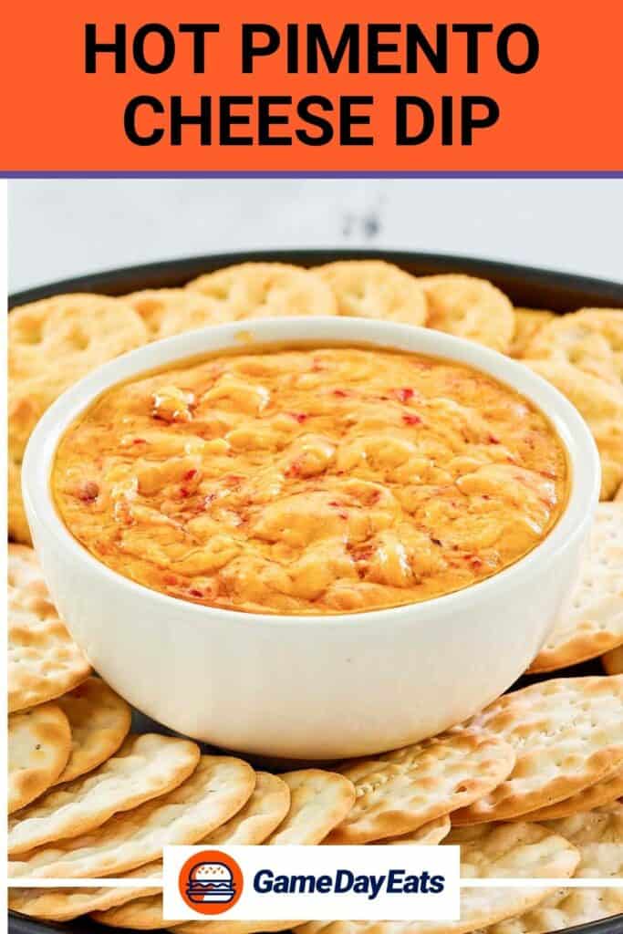 Hot pimento cheese dip and crackers on a black platter.