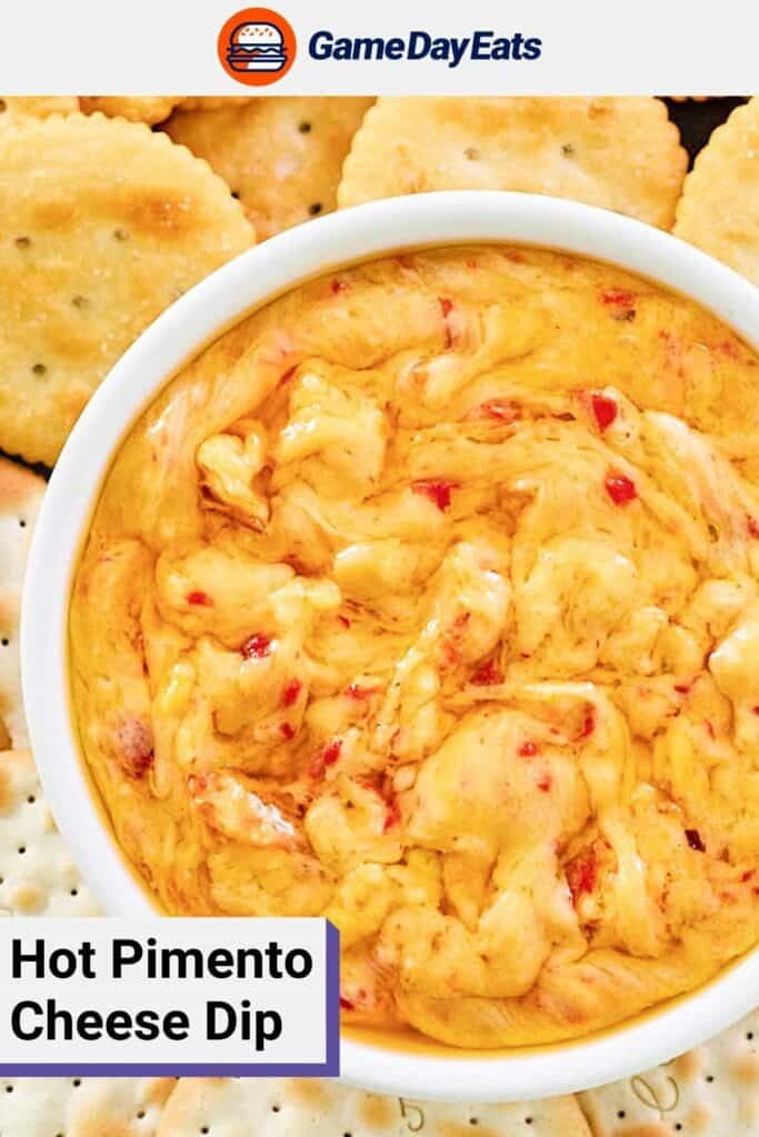 Closeup overhead view of hot pimento cheese dip in a bowl and crackers beside it.