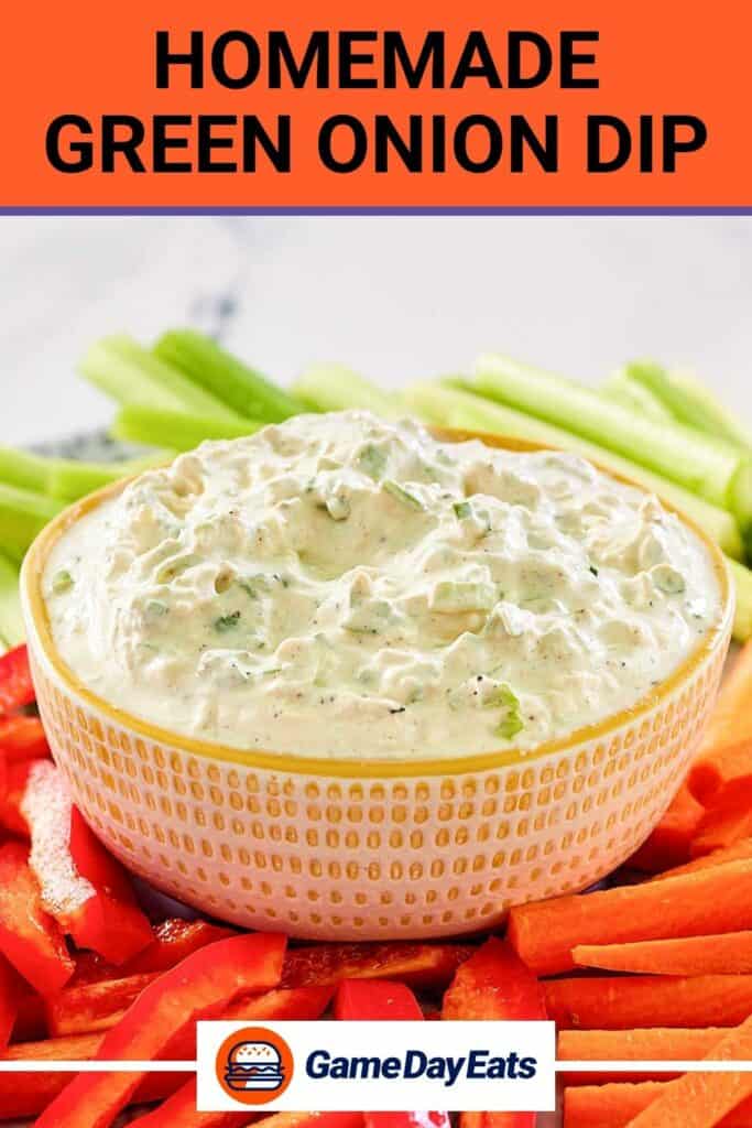 A bowl of homemade green onion dip and veggies around it.