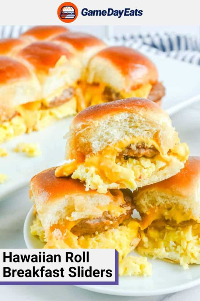 Three Hawaiian roll breakfast sliders with sausage on a plate.