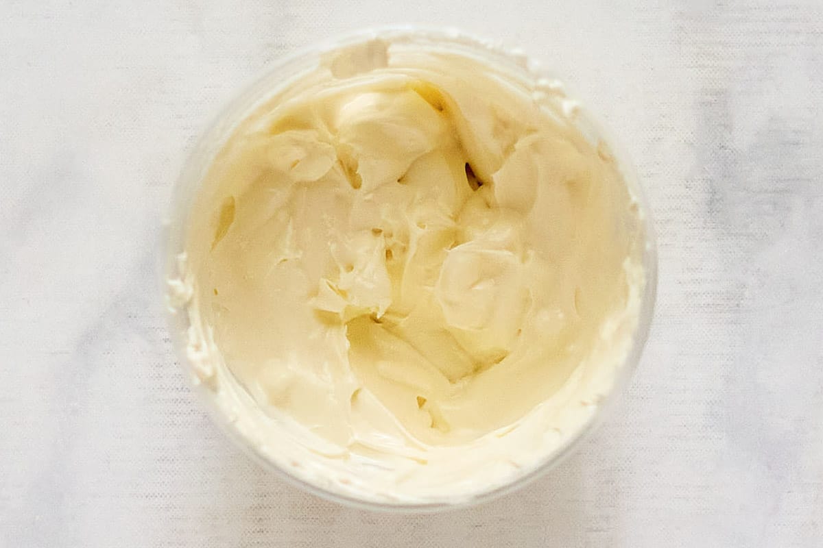 Softened cream cheese in a small glass bowl.