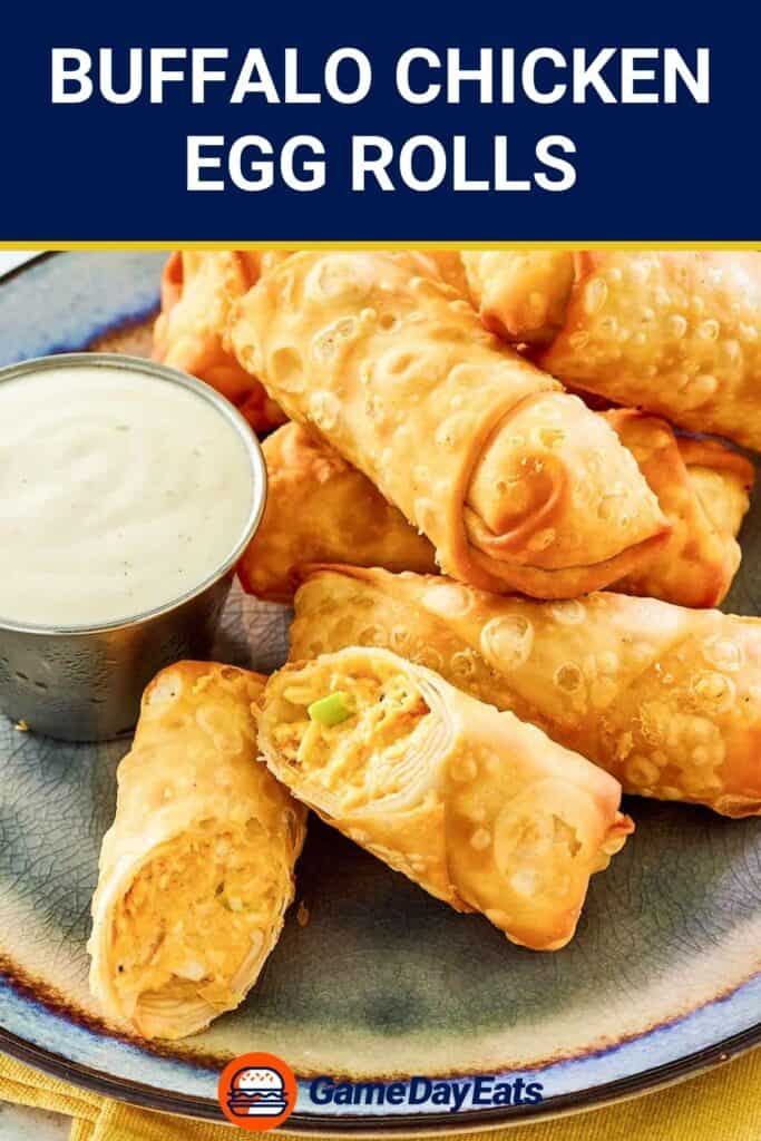 Several Buffalo chicken egg rolls and a cup of dipping sauce on a plate.