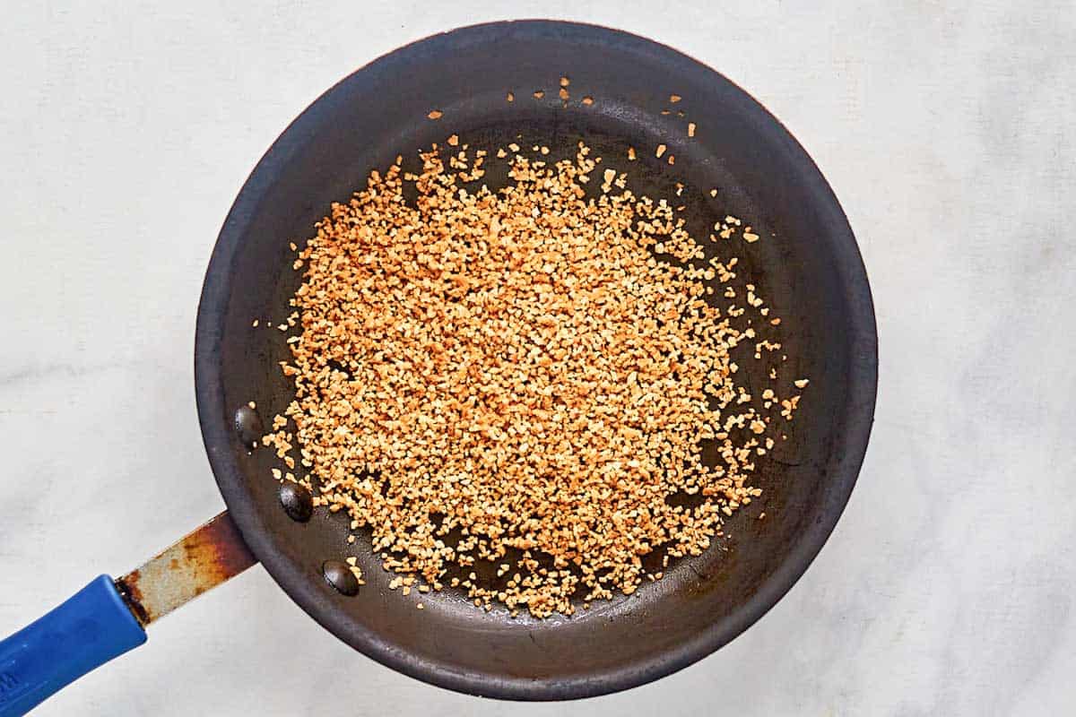 Toasted panko bread crumbs in a skillet.