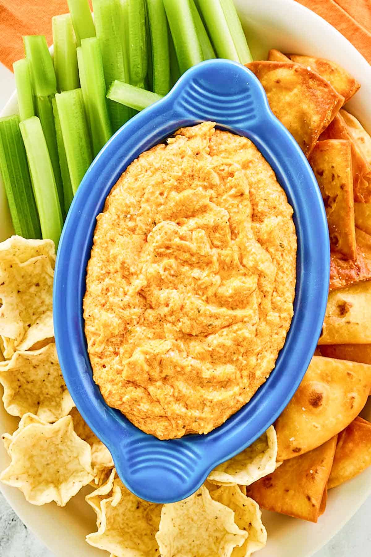 Copycat Hooters Buffalo chicken dip, celery, crackers, and tortilla chips.